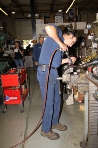 Dave Zehner drills new bungholes in the Switchback exhaust for the new oxygen sensors