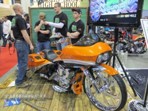 Members of the Sturgis Brown High School Student Build Challenge team sit at their display at the 26th annual Donnie Smith Bike Show