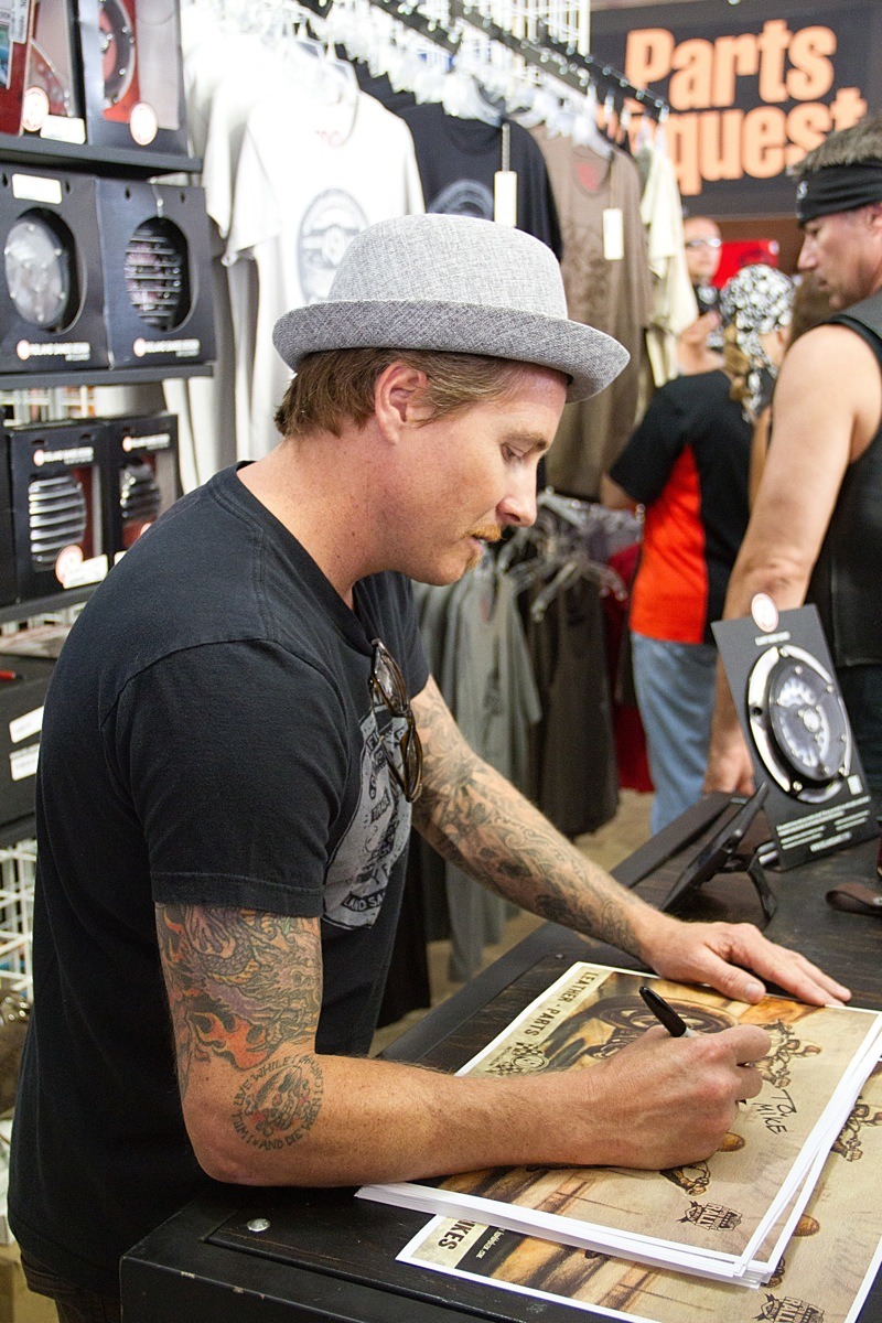 Bike builder Roland Sands kept busy talking to fans and signing posters