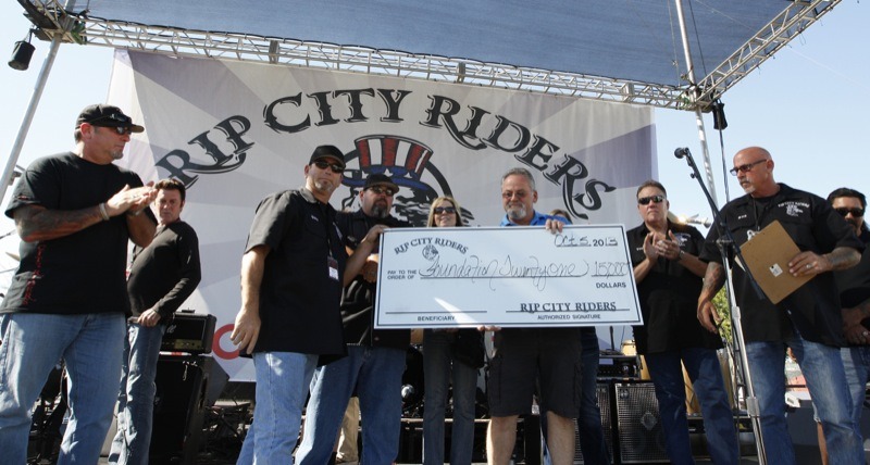 John Christopher (center, right), founder of Foundation 21, was on hand to receive a whopping $15,000 check from the generous Rip City Riders