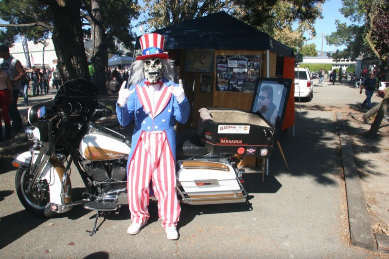 The Rip City Riders mascot poses with Chilly Billy's bike near the memorial display at the Petaluma Fairgrounds