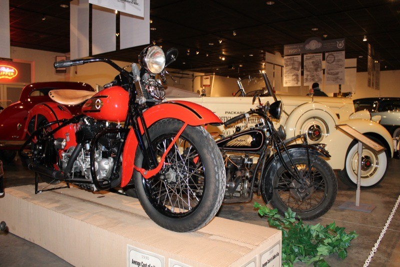 A 1937 Harley-Davidson UL and 1934 Indian Four blend in with the four-wheeled relics at the National Packard Museum