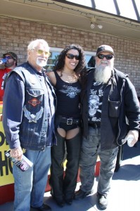W.T. "Roadblock" Harrell (l) and Willie Jones pose with a Tropical Tattoo hottie outside of the shop