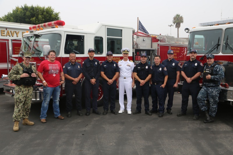 NBVC Chief Staff Officer Doug King (c.) flanked by Navy firefighters and police officers