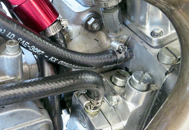 The engine side of the inlet valve hose… goes here… where the oil tank “vent” hose was connected to the cam cover. Couple things; it may seem counterintuitive to have air enter the cam case and not get out… but it does. The crankshaft creates suction when pistons are on the rise and air/oil mist in the cam case travels through the right main bearing into the crankcase and there’s one other thing that happens, which essentially is a key part of the “workaround” for the S&S reed valve’s inability to allow “normal” oil drawback. We’ll get to that...